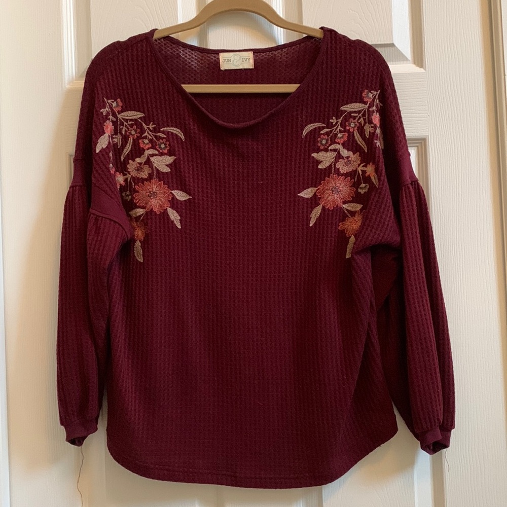 Women’s lightweight top with embroidered floral detail.